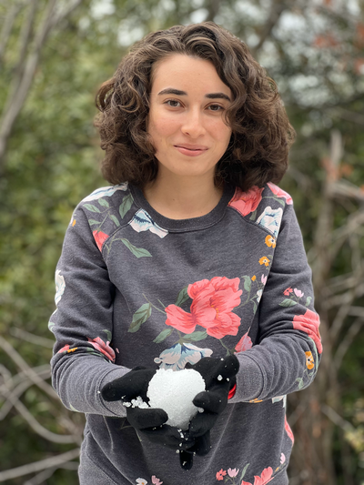 Woman happily holding a snow ball