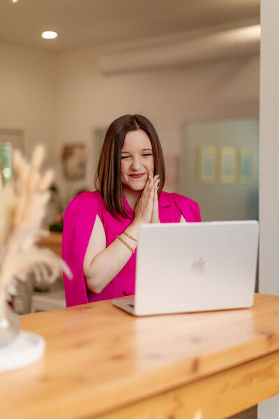 Woman holding coffee smiling at camera