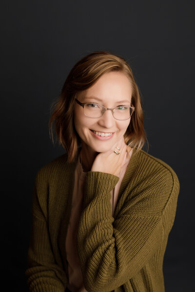 Elizabeth Rose smiling in a photo, radiating warmth and positivity, embodying the spirit of holistic wellness and care as a certified nurse, craniosacral fascial therapist, and wellness coach.