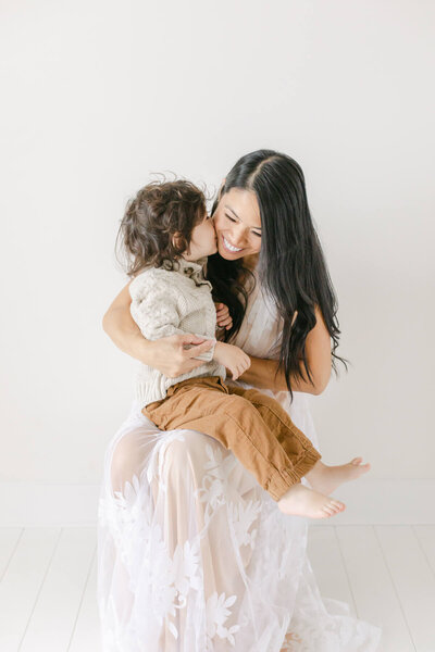mother shares a special moment for her family photographers session in omaha