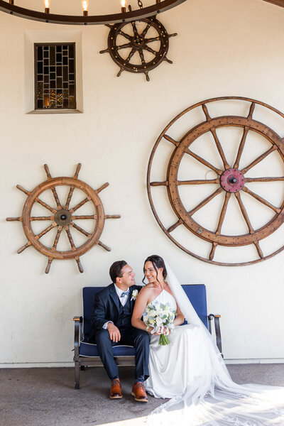 bride and groom sitting in front of Tom Hams Lighthouse San Diego