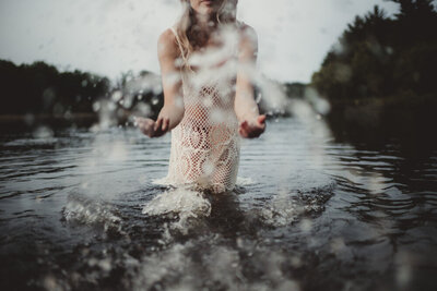 Caroline Weiss waist-deep in water, reflecting peace, surrender, and connection to flow.
