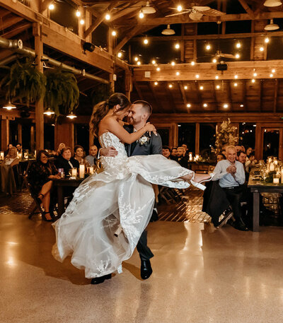 Groom spinning bride joyfully during wedding celebration at a Washington venue.