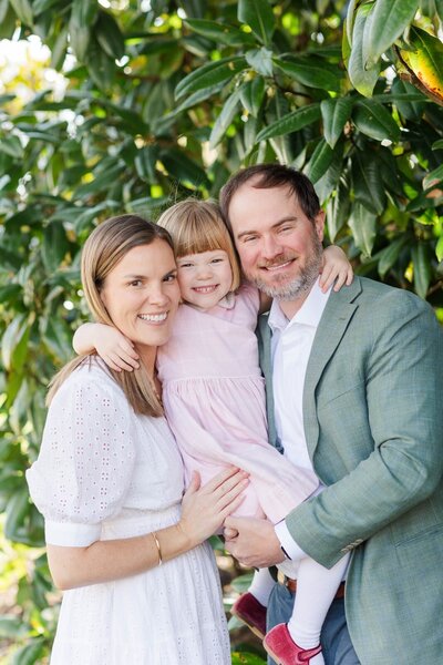 Husband & Wife and their two small children pulled in close for family photos in Richmond VA