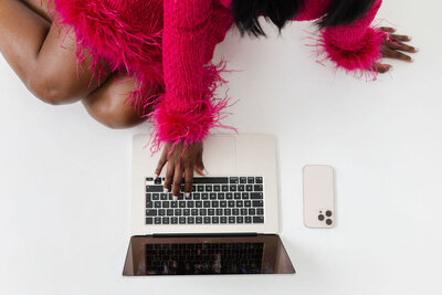 Colleagues typing on laptop collaborating