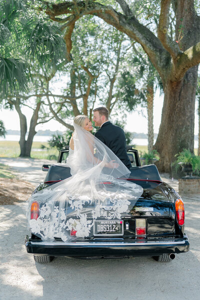 couple in front of their cleartop tented luxury reception Charleston Bride Weddings. Charleston destination wedding photographer.