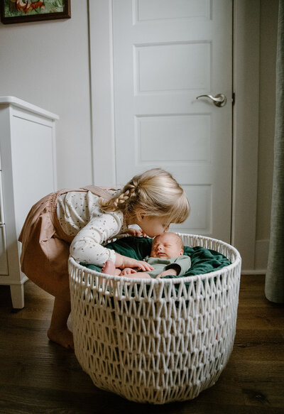 newborn in maroon outfit