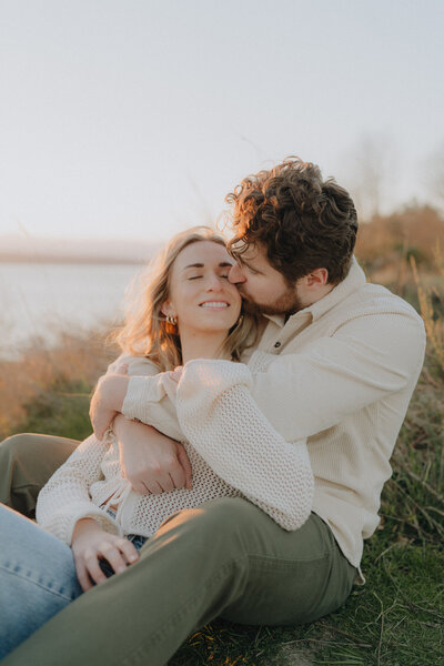 couple embracing in discovery park during golden hour