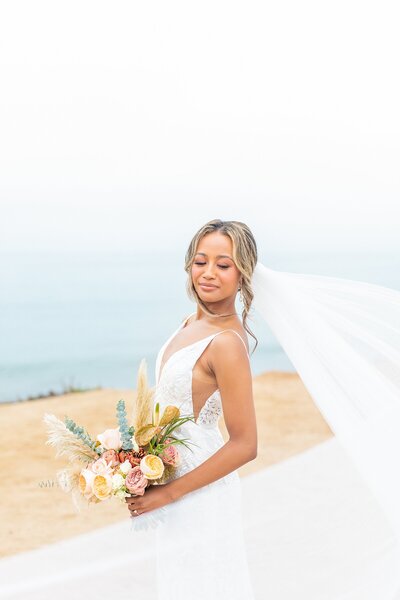 Bride holding bouquet at Hummingbird Nest Wedding Venue in Santa Susana, California. | Sherr Weddings
