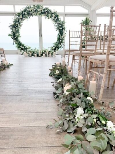 Long banqueting tables of flowers and candelabras for this beach side wedding