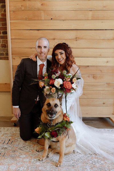 Bride and groom celebrate after their wedding ceremony with a burgundy and pink bouquet  at Lionsgate Event Center North of Denver, Colorado.