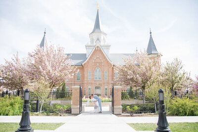 Wedding couple dramatically kissing and dipping in front of the Provo City Center Temple, moment captured by Las Vegas Wedding photographer, Jessica Bowles