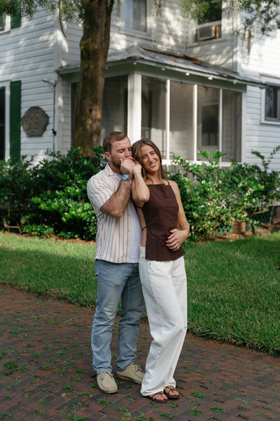 Couple posing with guy kissing her hand for florida engagement photographer, Shelby Ann Photos