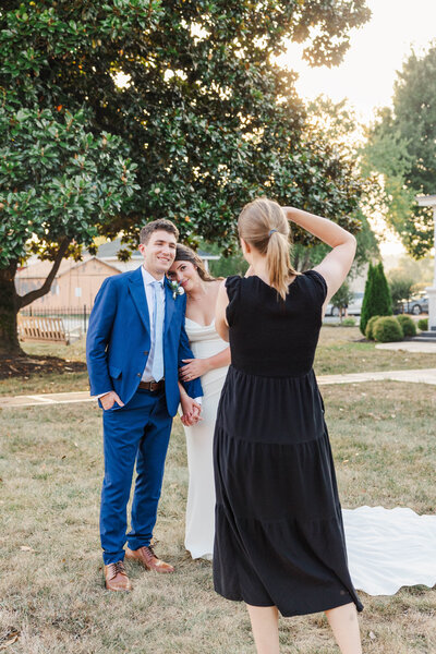 Michelle Bordenkircher takes a photo of a couple on their wedding day