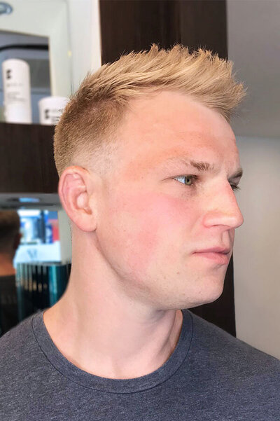 Men’s haircut featuring short blonde textured layers with a clean fade, styled by Blake & Kwan Hairdressing Sydney.