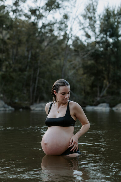 Portrait of a pregnant women standing in the Murrumbidgee River in Canberra.