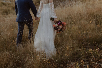 Bride and groom hold hands in Telluride