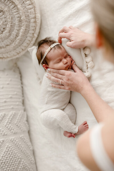 newborn photographer in denver colorado posing a baby in their studio