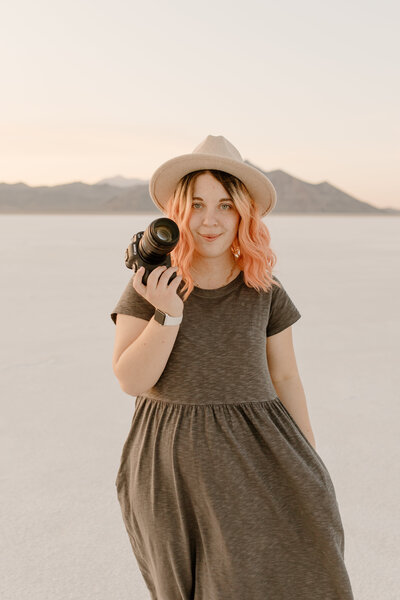 abi teeters holding a camera at the bonneville salt flats in utah