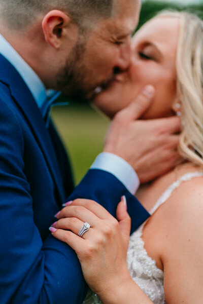 Close-up of emotional elopement kiss with bride and groom holding each other's face