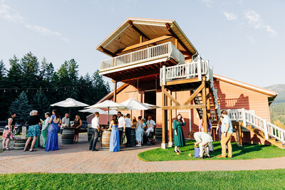 Outdoor wedding reception by barn at The Barn at Finley Point in Polson, MT