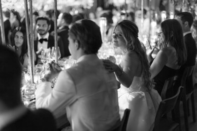 bride and groom sitting at reception table