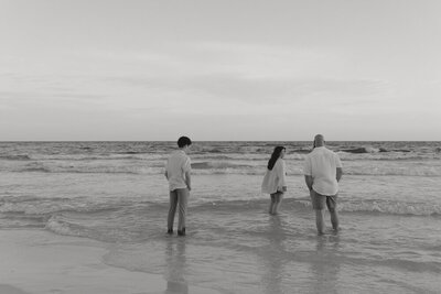 A black and white photo of Michaela and her family on the ocean in Santa Rosa Beach, FL. 