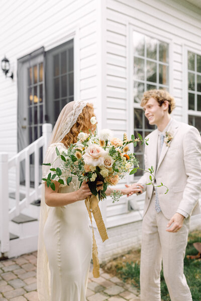 Groom Jon shares a candid laugh during his backyard wedding in Richmond, Virginia, exemplifying documentary-style wedding photography.