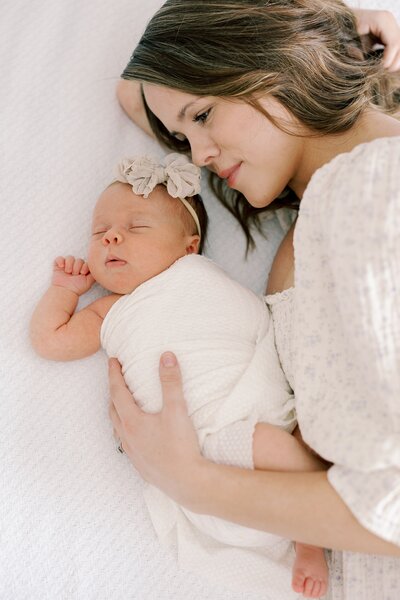 A photo of mom gazing down a her beautiful baby girl