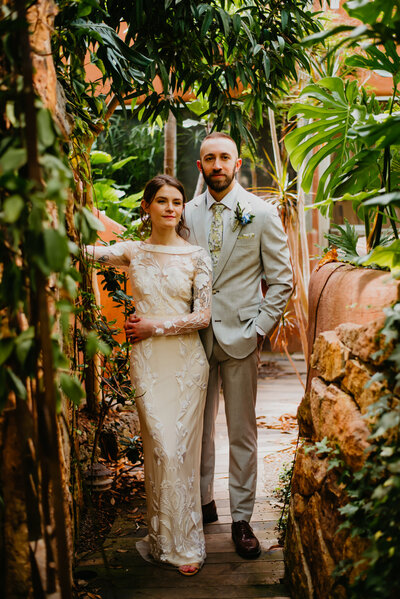 Newlyweds walk through a beautiful green house and Garden in Santa Fe, New Mexico