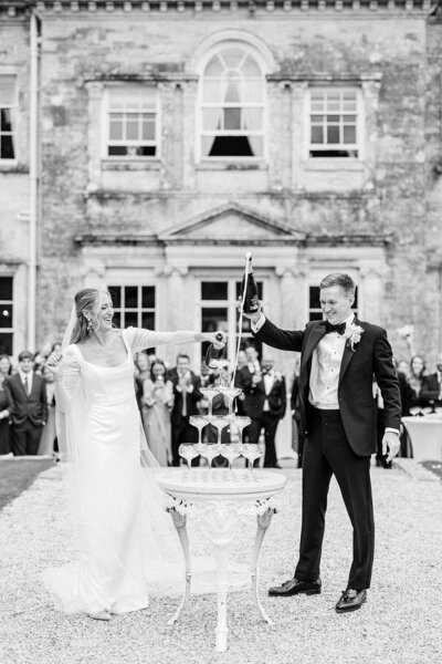 Bride with open back dress posing for portrait with groom