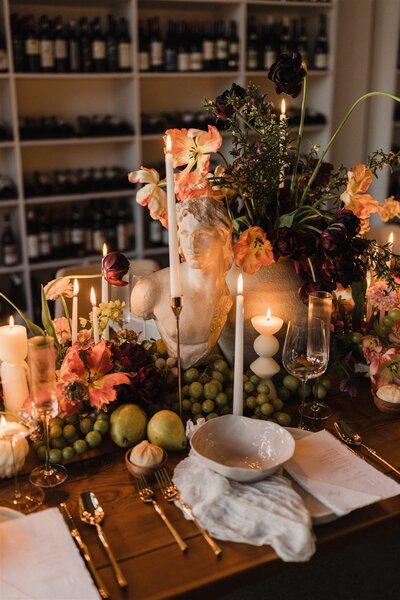 Modern baroque wedding table with sculpture, candles, and hellebore