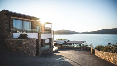 Beautiful home on the edge of a lake at sunset