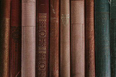 Spines of vintage books in red and teal