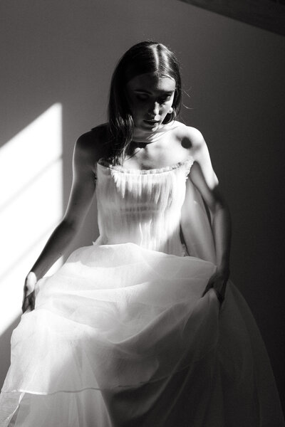 black and photo photo of a bride and groom walking away from the camera