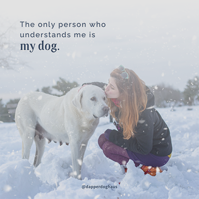 Image of woman kissing dog in the snow with a quote on top