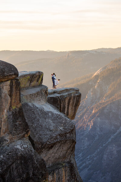 Newlyweds dance and hug on top of one of the best Yosemite Elopememt Locations!