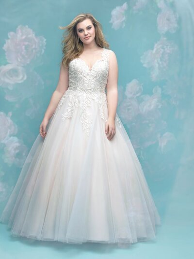 This gorgeous tulle ballgown features lace across the bodice and sheer illusion back.
