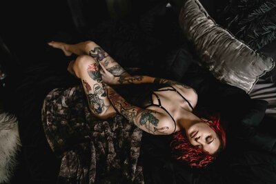 dark-and-moody-red-headed-women-laying-on-bed