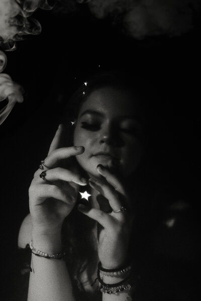 A moody couple in peasant clothes walks in the fog with lanterns.