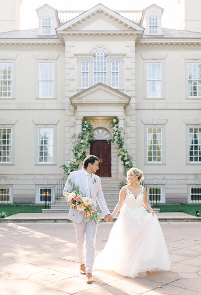 Bride and groom walking in front of Great Marsh Estate in Bealeton, Virginia. Captured by DC Wedding Photographer Bethany Aubre Photography.