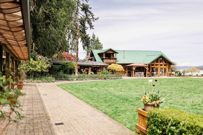 rustic Kiana Lodge barn, showcasing, green gardens and blue skies