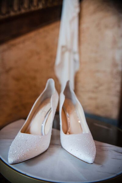 A bride's special wedding shoes glitter in the morning light.