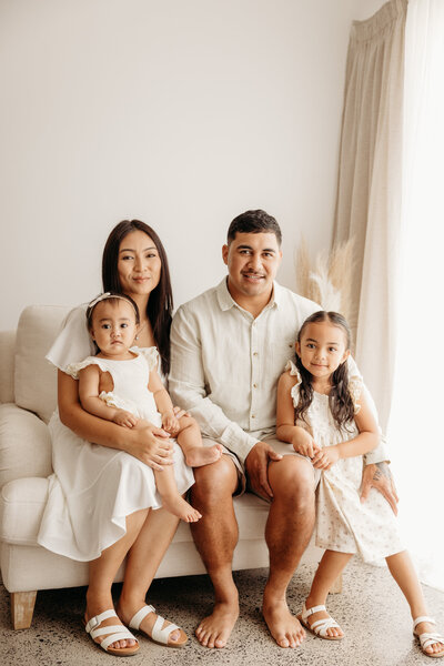 Ammika and her family posing for a family portrait in michelle kellys auckland photography studio