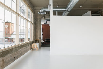 Fargo photographers brand session behind the scenes - Hair stylist adjusting a blonde model’s hair during a headshot session, highlighting collaboration and attention to detail in salon branding.