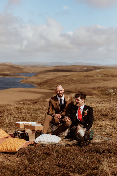 groom and groom enjoy all-inclusive wedding picnic