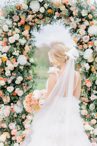 Natalie Stevenson Photography and Flourish and Grace florist Paris, flower wedding arch with peach and ivory flowers