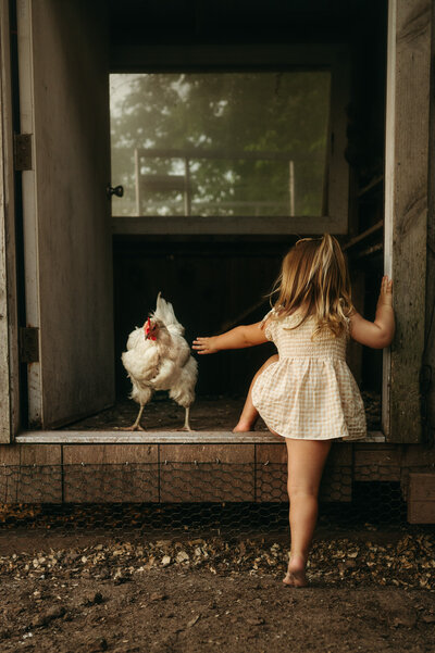 Young girl in a ruffled tulle dress twirling in the sunset. 