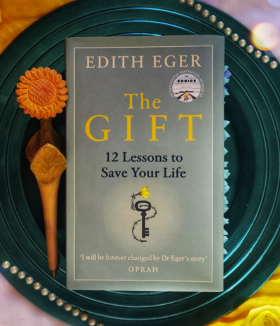 The Gift book sitting on a earthy green plate