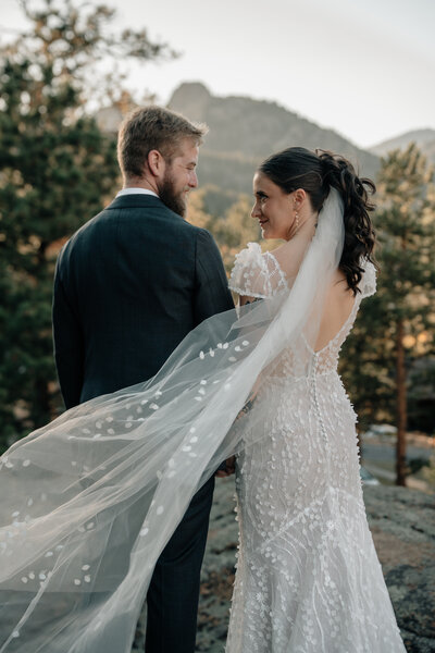 White florals and greenery at an indoor wedding ceremony.